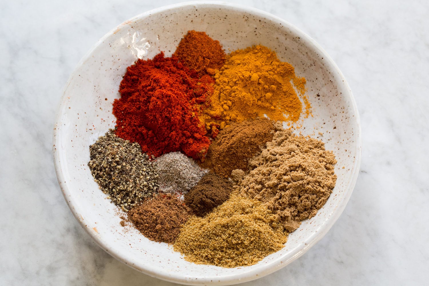 Slow Cooker Chicken Tikka Masala Indian spices in a small white bowl.