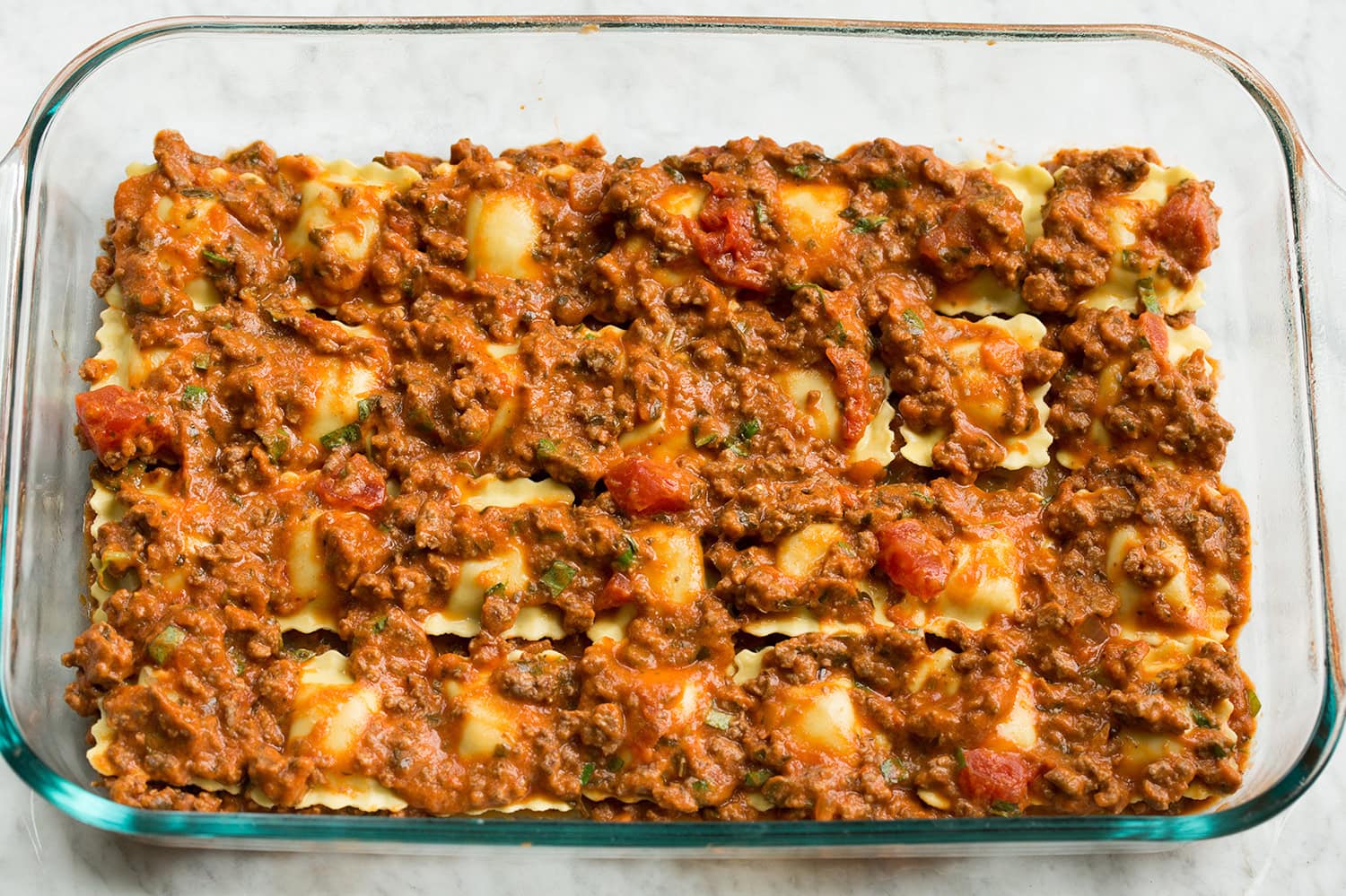 Beef sauce added over ravioli