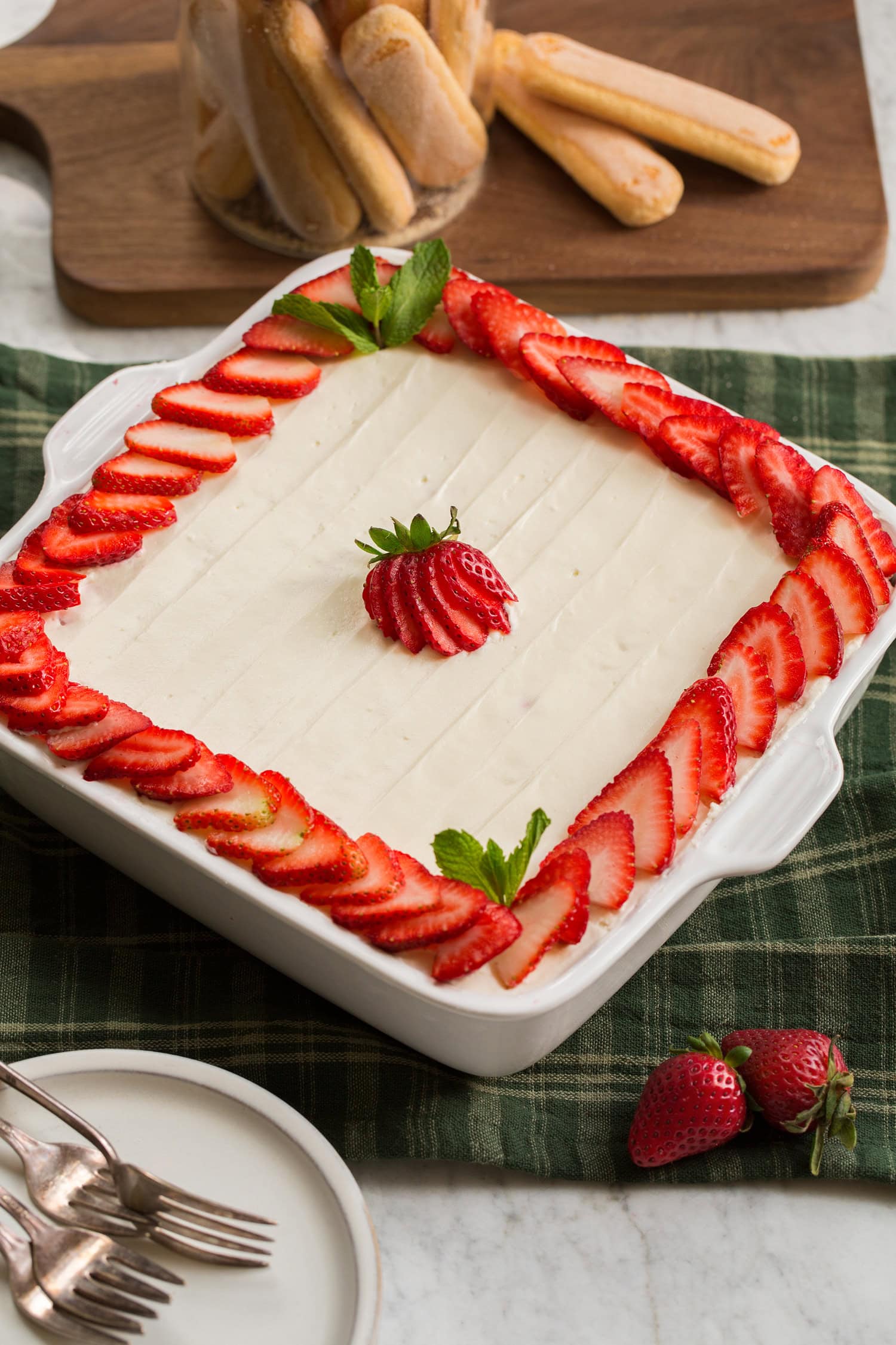 Strawberry Cheesecake Tiramisu Strawberry Cheesecake Tiramisu shown as a whole square cake in baking dish.