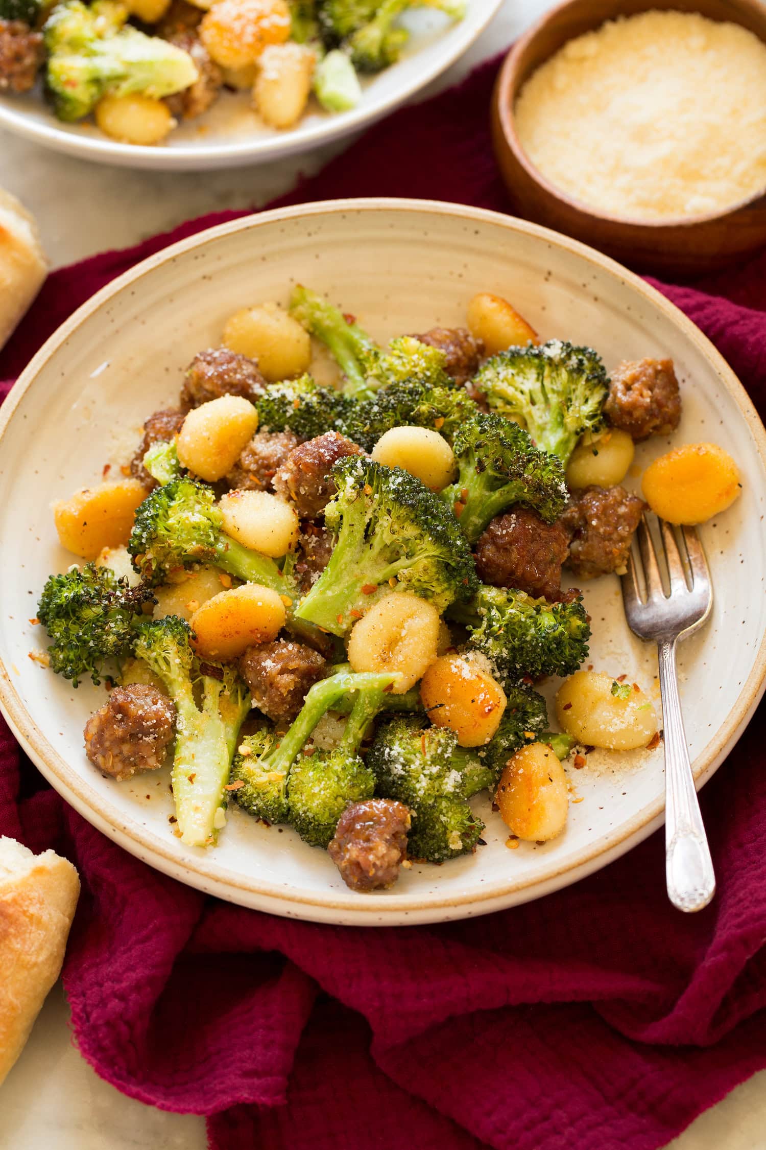 Serving of oven gnocchi with roasted broccoli and sausage.