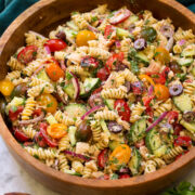 Tuna pasta salad in a wooden bowl.