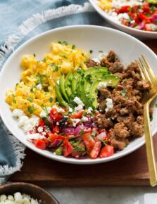 Breakfast bowl made with turkey sausage, scrambled eggs, pico, avocado and feta.