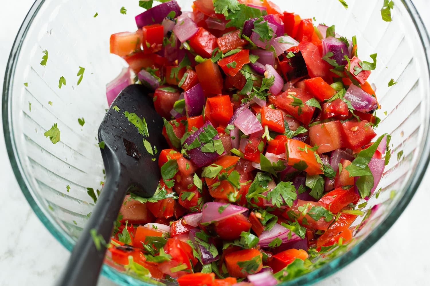 Breakfast Bowls Bell pepper pico tossed together in a mixing bowl.