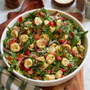 Tortellini pasta salad with four cheese tortellini, arugula, bacon, tomatoes and bell peppers.
