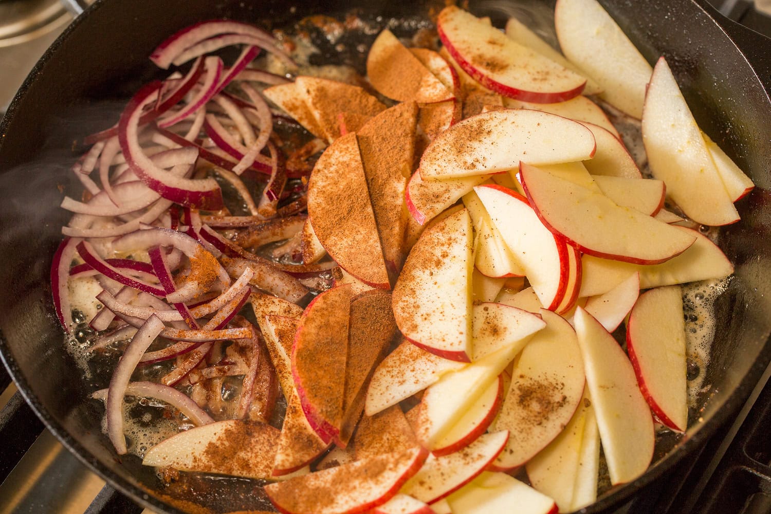 Apple Chicken Apples spices and red onions added to skillet.