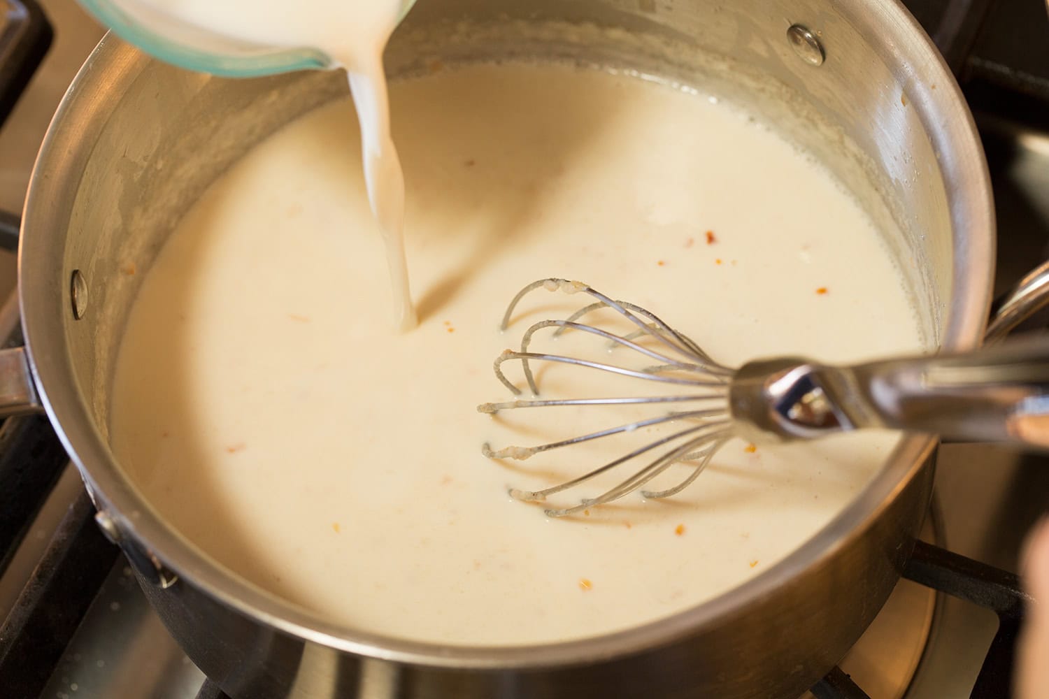 Milk mixture whisked into rough in saucepan.
