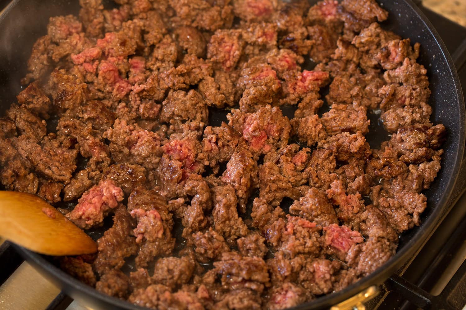 Slow Cooker Ground Beef Stew Crumbled nearly cooked through ground beef in a skillet.