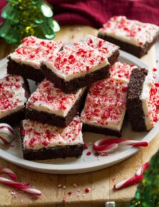 Plate of stacked frosted peppermint brownies.