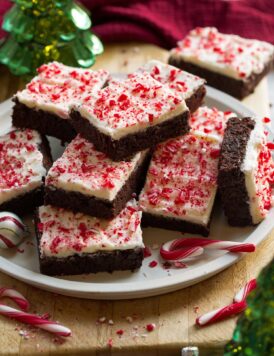 Plate of stacked frosted peppermint brownies.