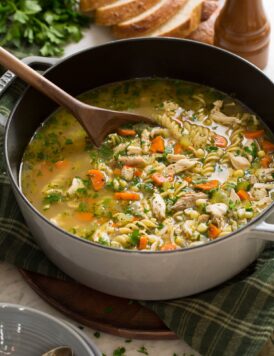 Pot filled with homemade turkey soup made from leftover turkey and carcass.