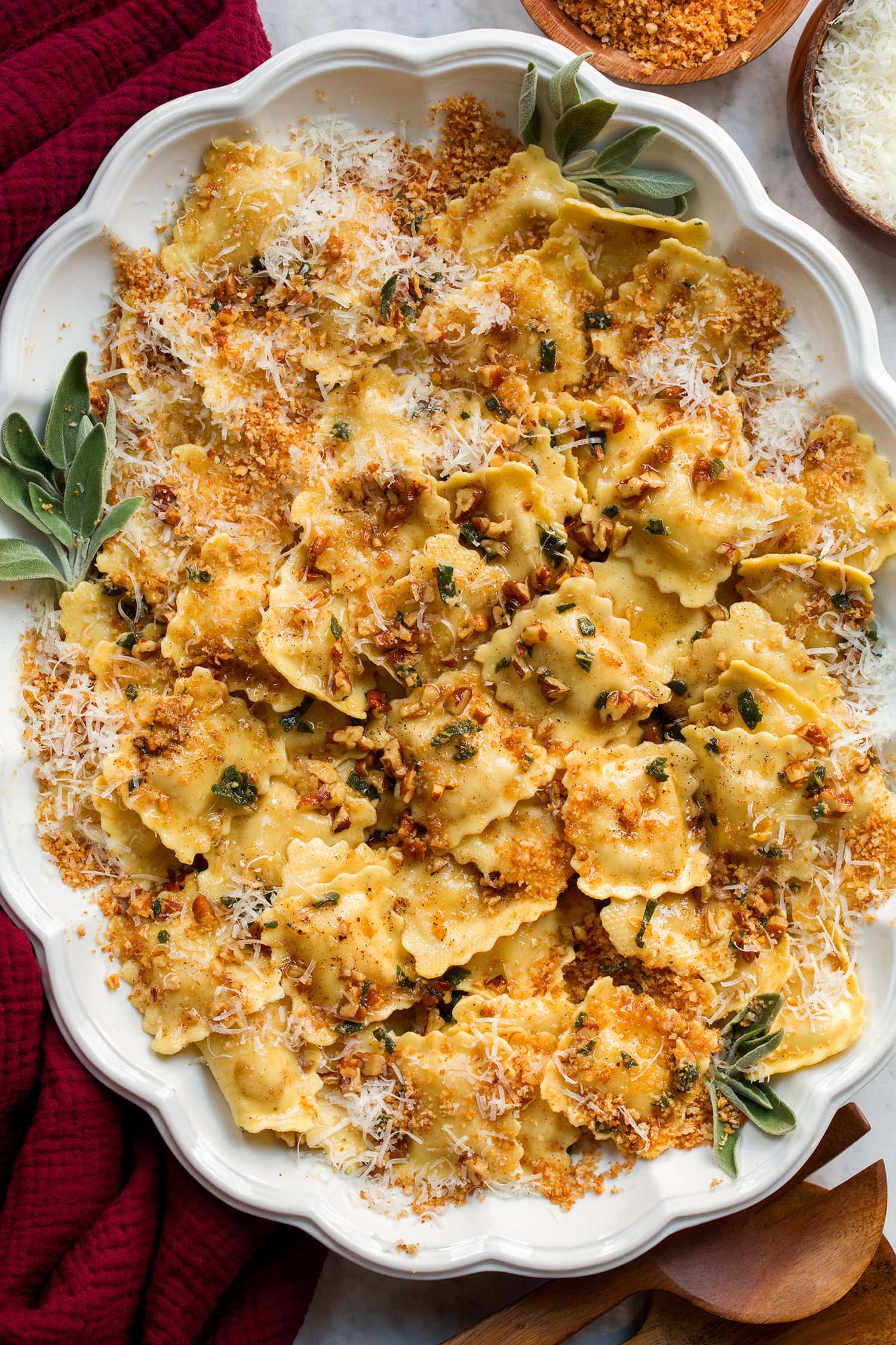 Browned butter sage sauce shown tossed over ravioli with bread crumbs.