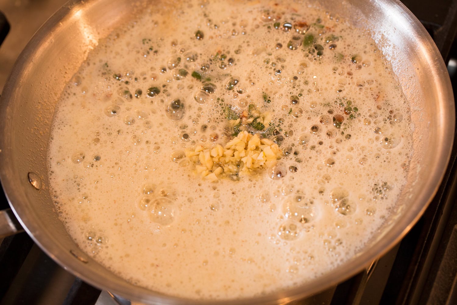 Garlic added to foaming browned butter sage sauce.