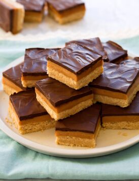 Stacked pyramid of millionaire's shortbread bars.