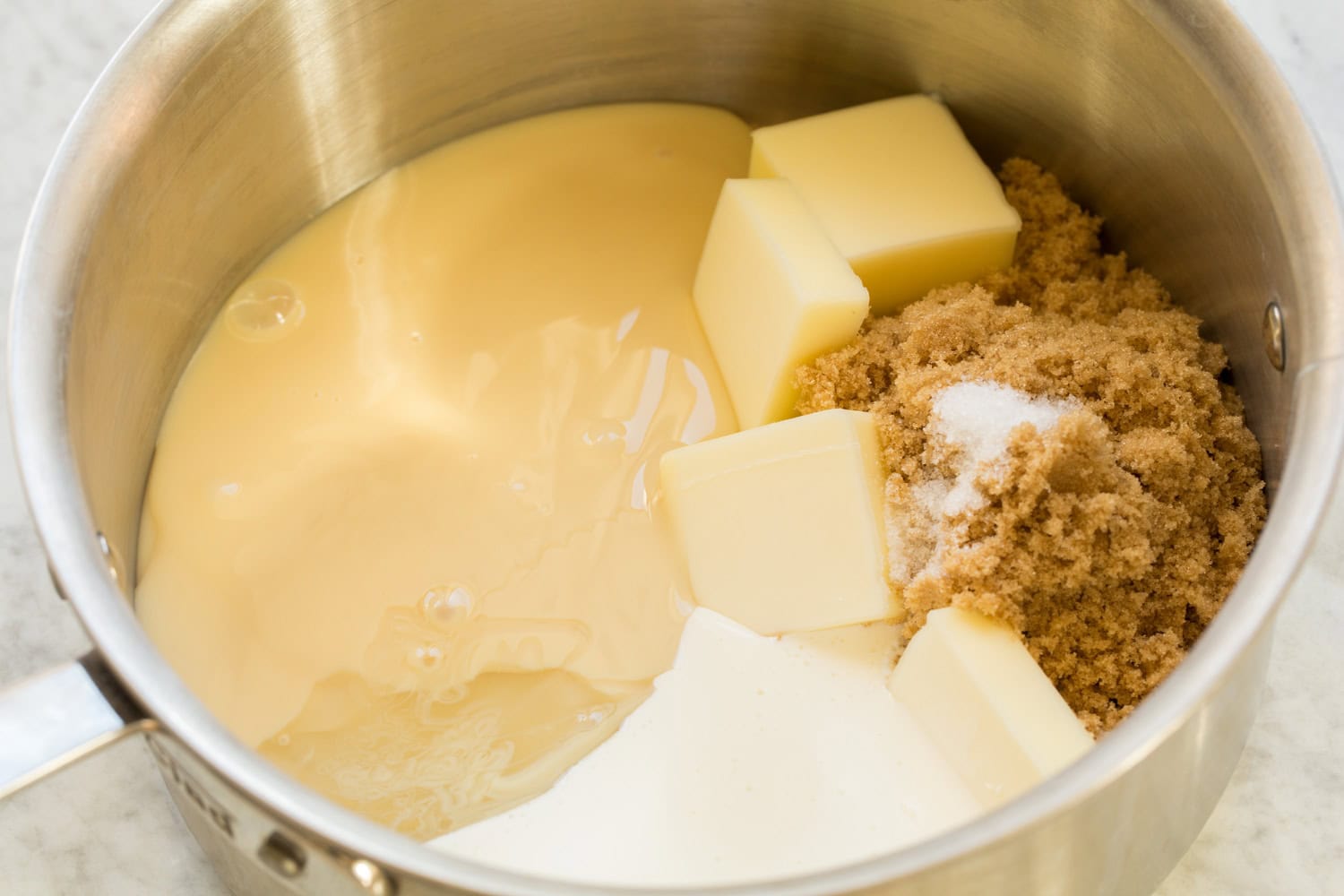 Caramel ingredients shown before melting together in a saucepan.
