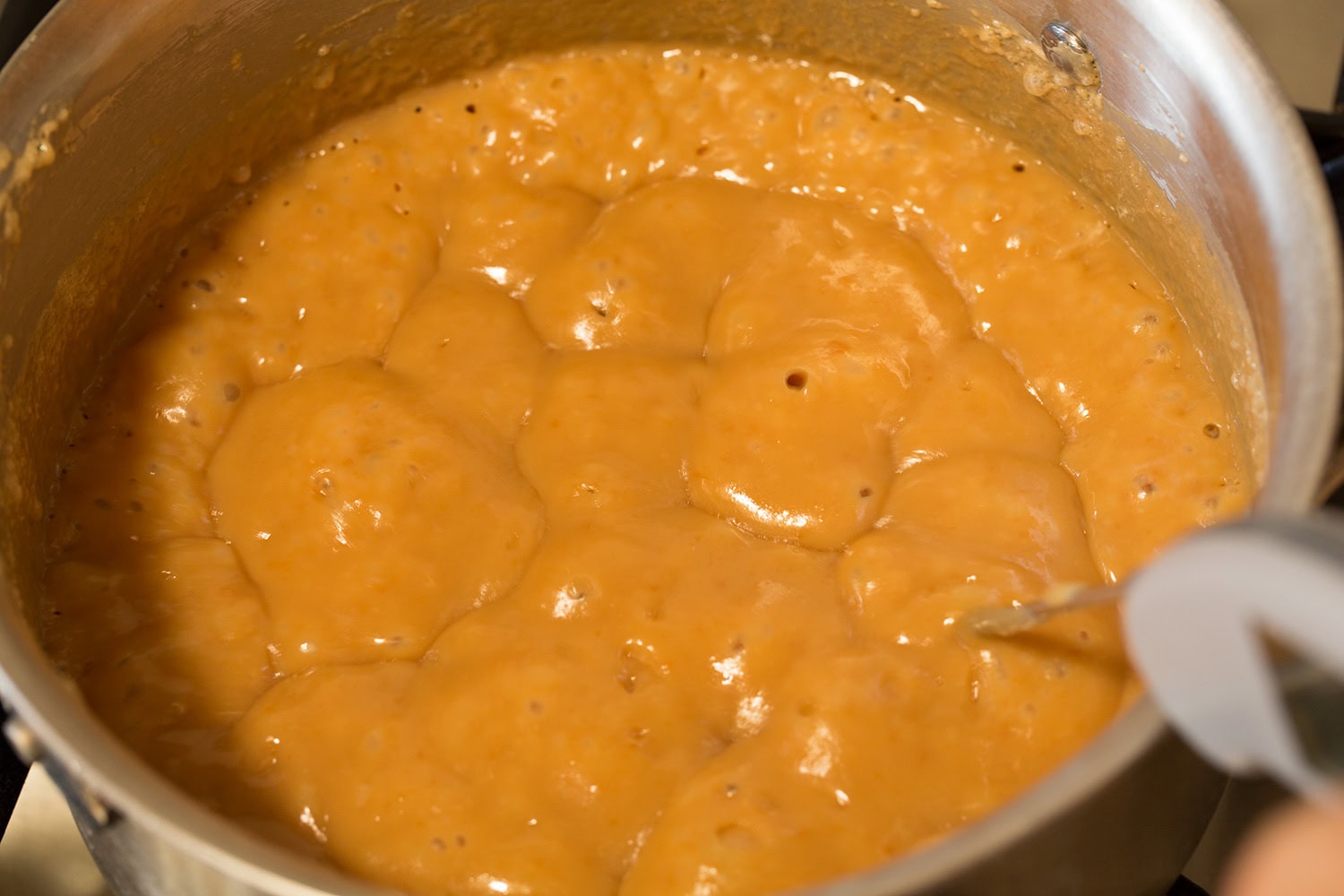 Caramel shown after caramelized in a saucepan.