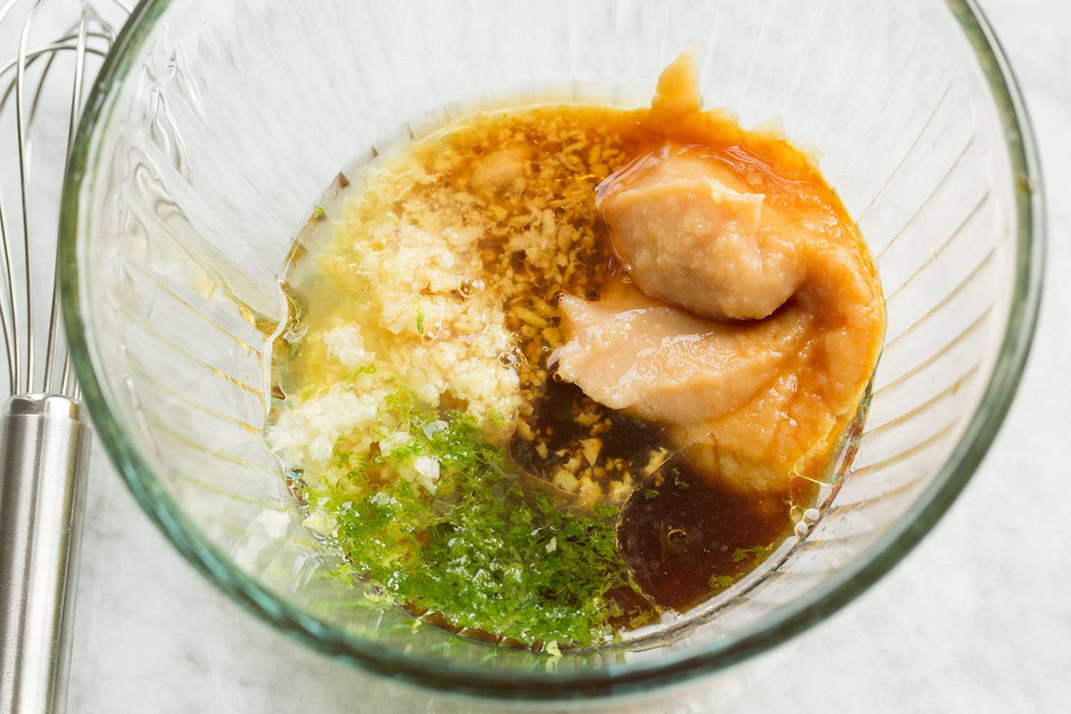 Miso marinade before mixing ingredients together in glass mixing bowl.