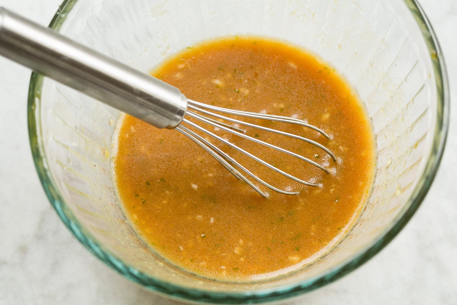 Miso pasta marinade shown after mixing in glass bowl.