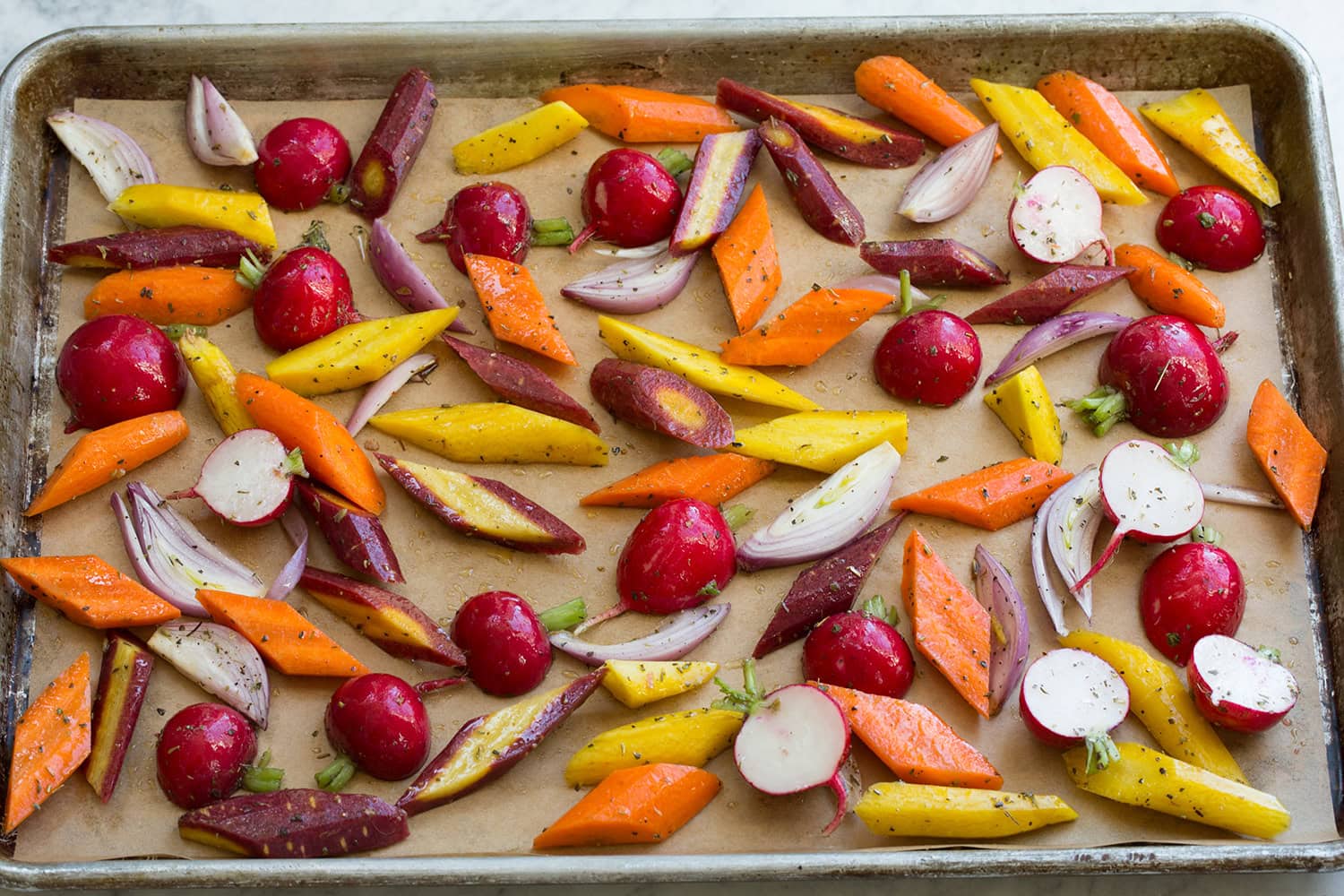 Vegetables shown before roasting on baking sheet.