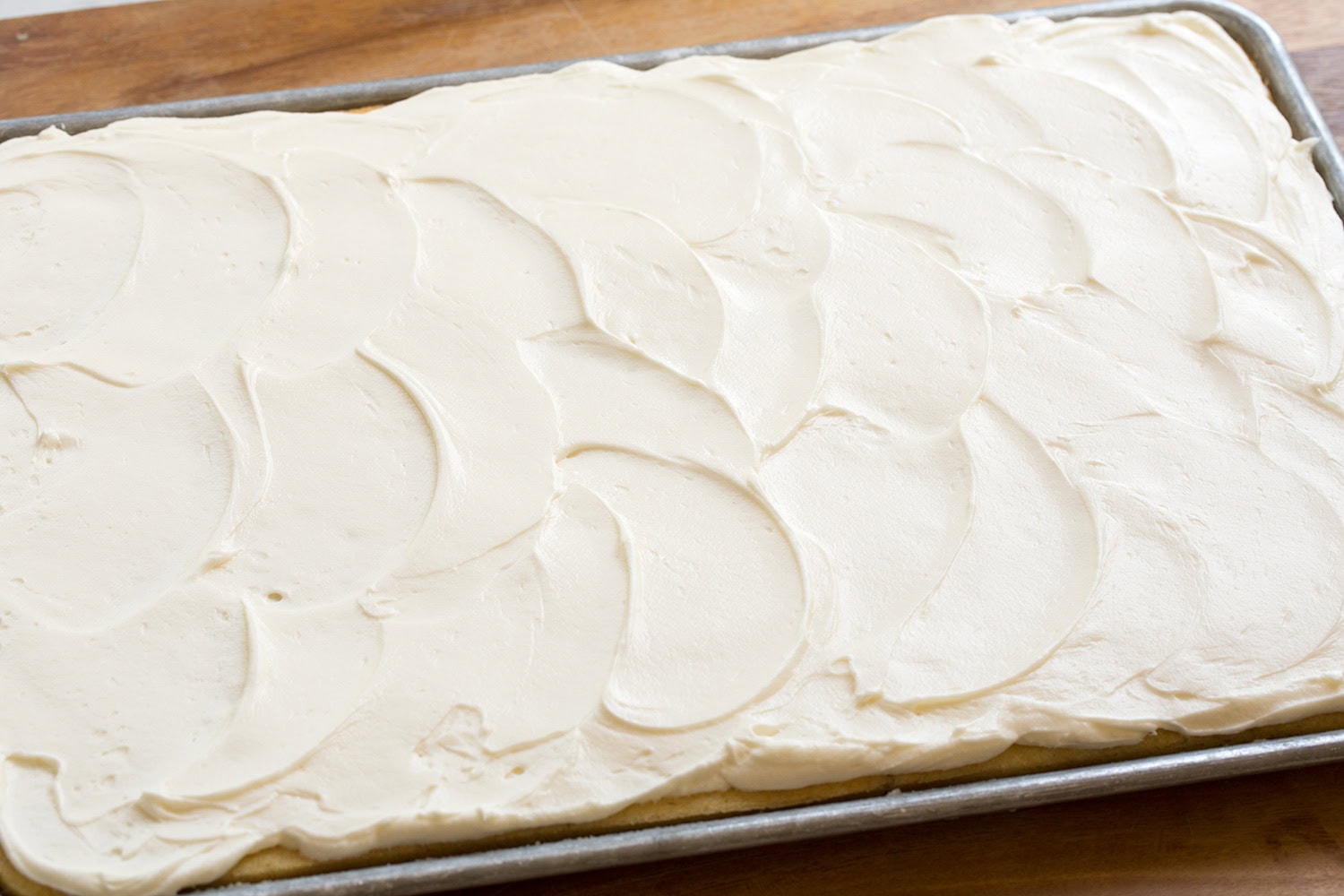 Frosting spread over a sheet cake.