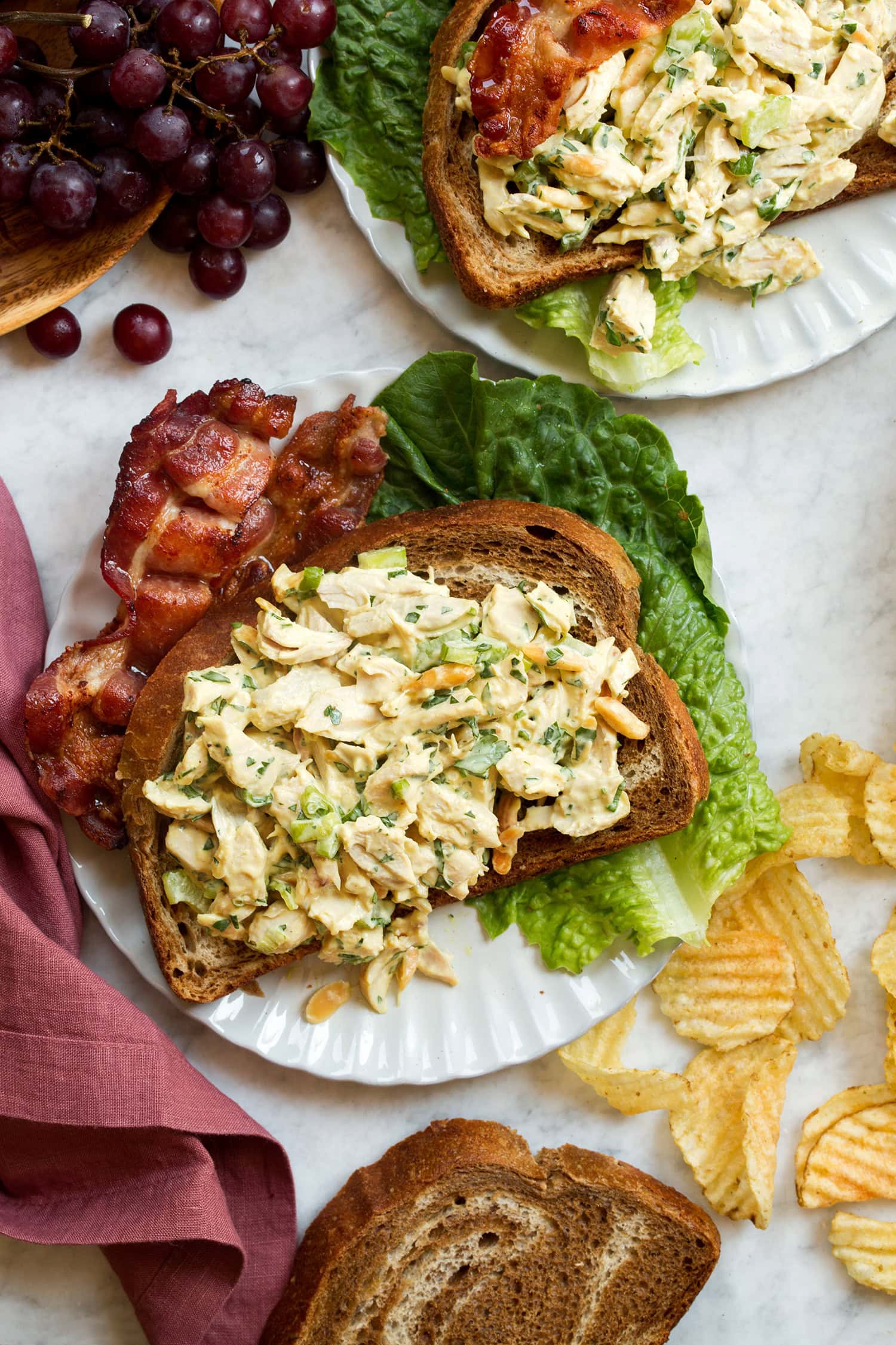 Two open face honey mustard chicken salad sandwiches shown from overhead.