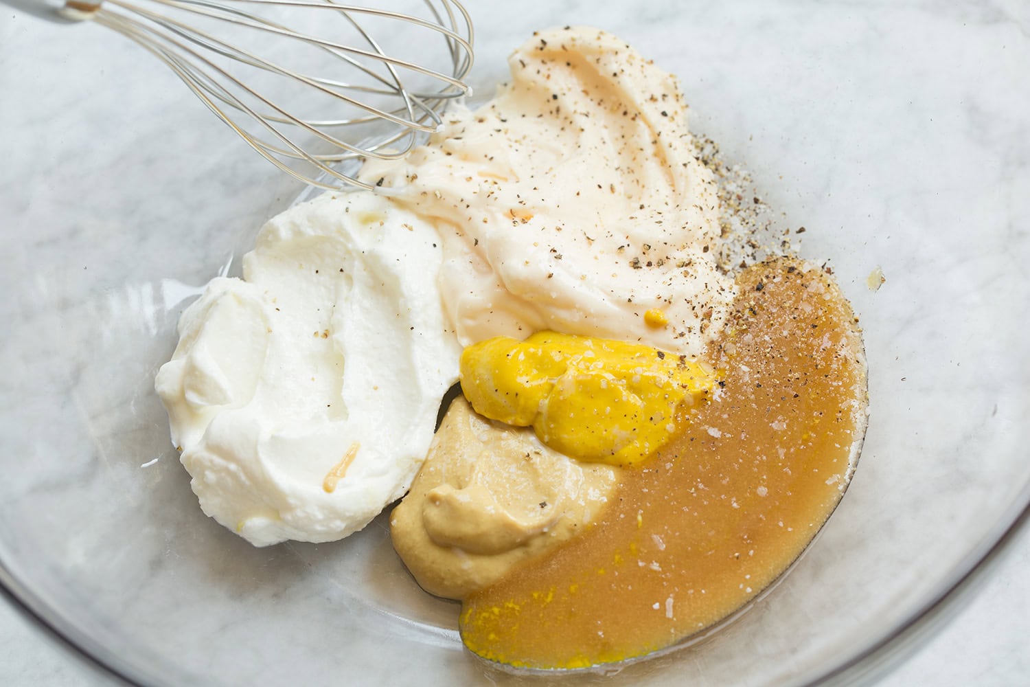 Creamy honey mustard chicken salad dressing shown before mixing.