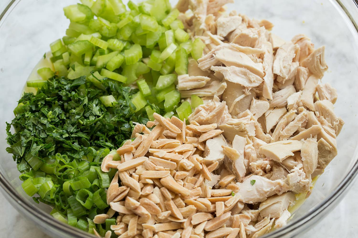 Prepared chicken salad ingredients in a bowl shown before adding dressing.