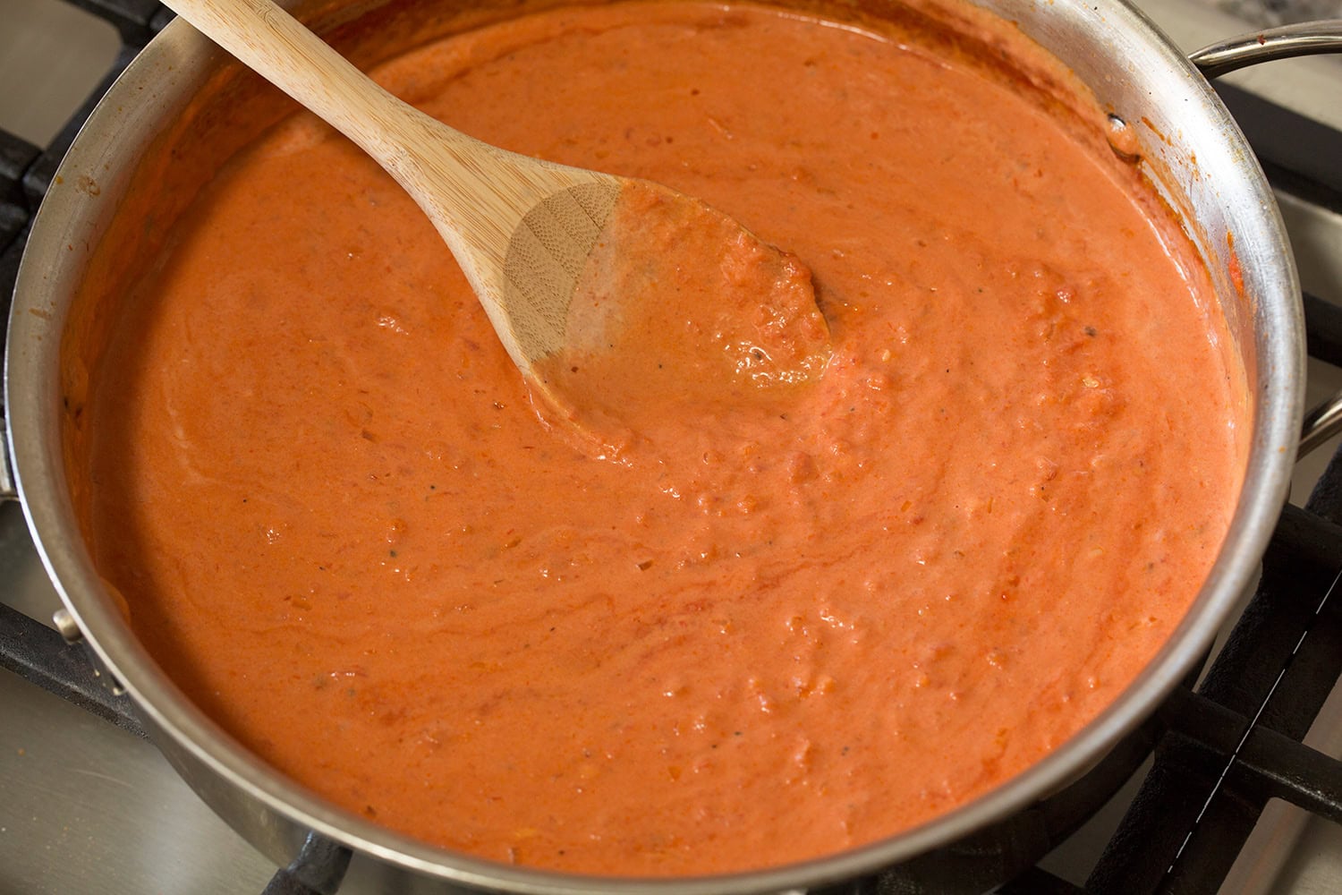 Heavy cream and tomato sauce shown fully blended together.