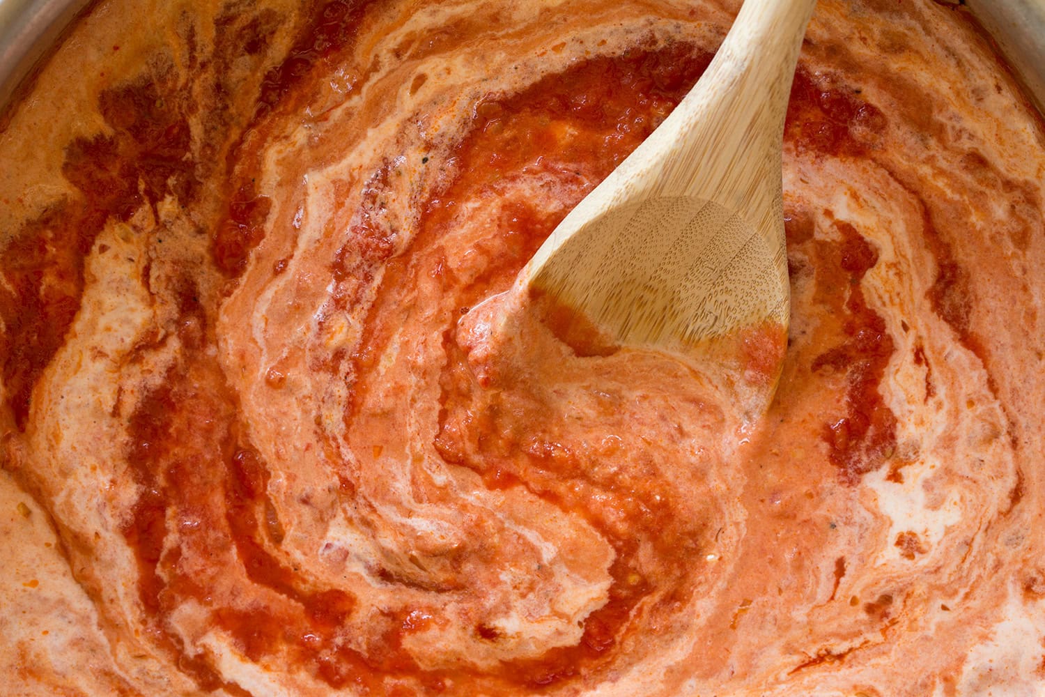Tomato sauce with heavy cream swirled into it.