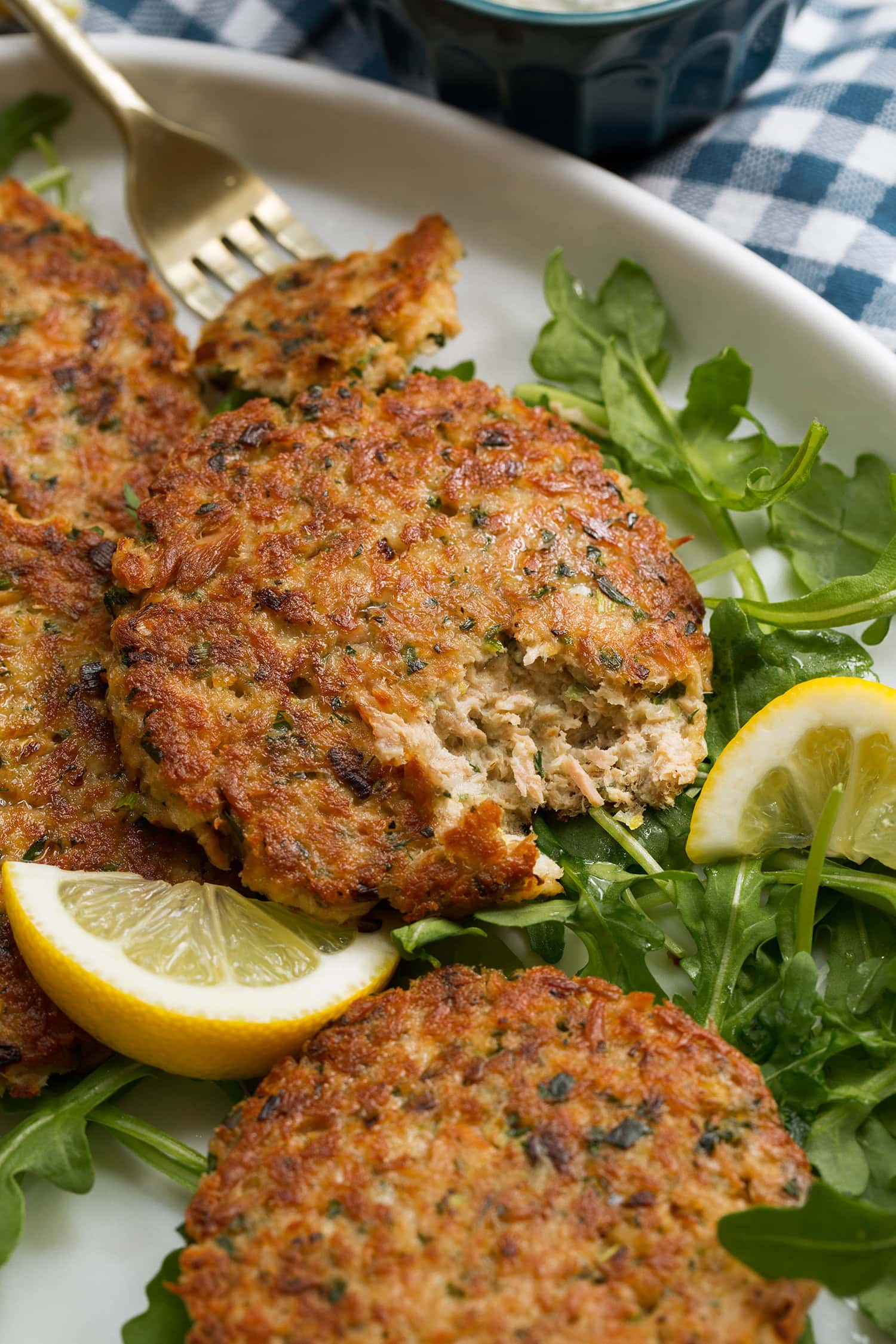 Tuna patty shown close up with a portion cut into with a fork to show interior texture.